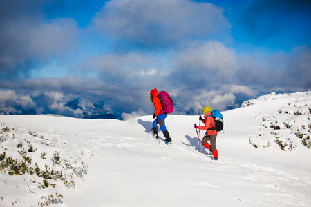 tourists walk in the snow in the mountains during the winter holidays in the mountains, winter in the Ukrainian Carpathians.
の写真素材