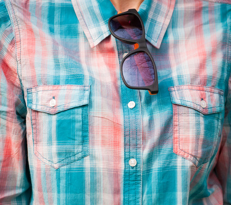 Shirt in pink and blue cage with glasses on the collar.の写真素材