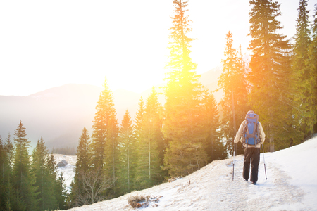 Adventure man hiking wilderness mountain with backpack, outdoor lifestyle survival vacation.の写真素材