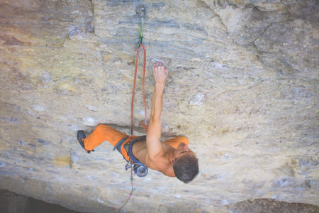 rock climber climbs the cliff using ropes and equipment, the employment of sports climbing.