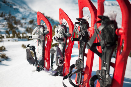 Snowshoes standing in the snow against the background of snow and mountains. Winter walks with forests and mountains.の写真素材