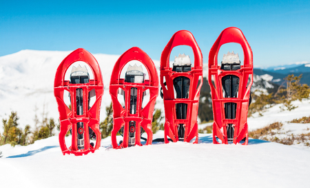 Snowshoes standing in the snow against the background of snow and mountains. Winter walks with forests and mountains.の写真素材