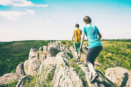 Two girls with a backpack walk in picturesque places.の写真素材