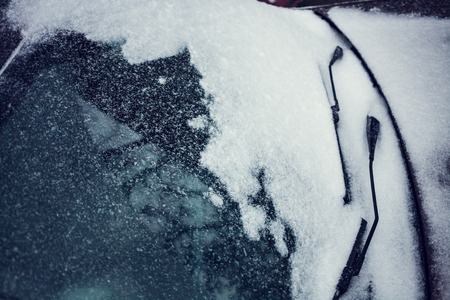 Snow covered car. Winter parking. Rearview mirror covered with snow.の写真素材
