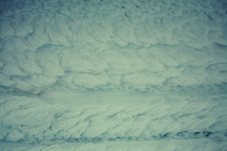 Snow-covered wall of the hut. Wooden boards covered with snow. Icy house.