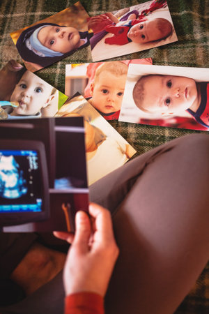 A picture of an ultrasound examination of a pregnant woman. Mom looks at the sonogram. A woman looks at old photos and gives herself up to memories. Old photos.の写真素材