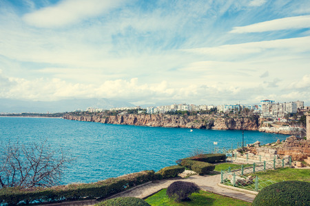 Sea coast of Antalya. Sea shore. Turkish resort. Urban buildings on a rocky beach.の写真素材