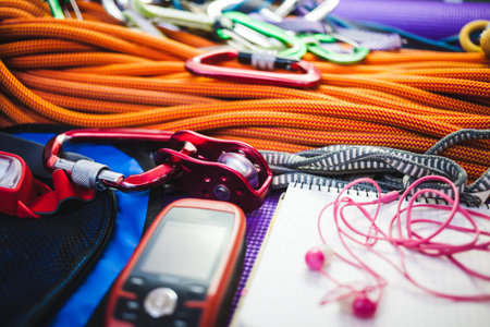 Roller, rope, navigator, carbine and notepad. Equipment for mountaineering. Notebook and equipment...