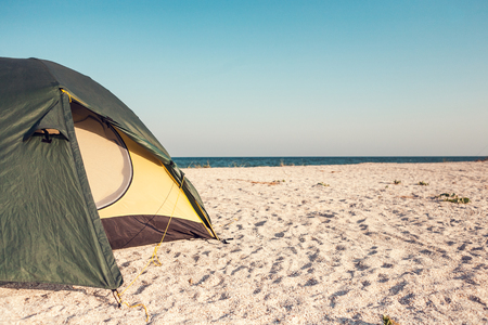Tent on the sea coast. Camping on the ocean coast. Rest on the sandy beach.の写真素材
