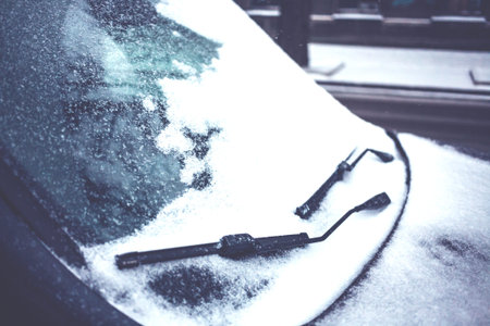 Snow covered car. Winter parking. Rearview mirror covered with snow.の写真素材