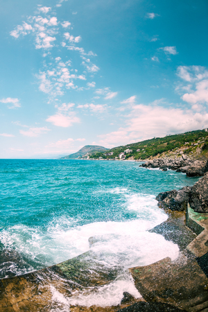 Storm on the sea coast. Stony shore of the ocean. Waves breaking on the stone coast.の写真素材