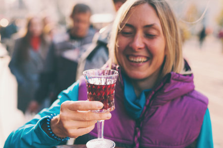 Woman holding a glass of red wine. Cherry brandy. Girl tasting alcoholic drink. Alcohol addiction.