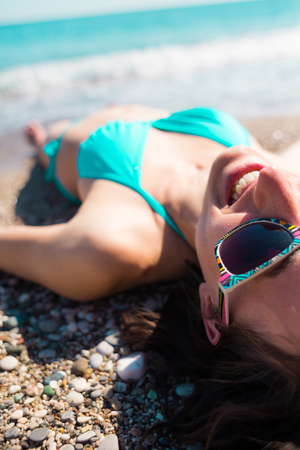 face of a girl resting on the beach. happy girl resting by the ocean.の写真素材