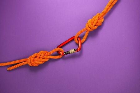 Red carbine with clutch. Equipment for climbing and mountaineering. Safety rope. Knot eight.の写真素材