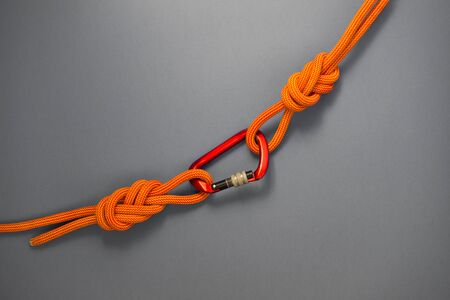 Red carbine with clutch. Equipment for climbing and mountaineering. Safety rope. Knot eight.の写真素材