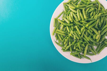 Asparagus beans on a white plate. A legume plant. Boiled beans. Vegetarian dish on a blue background.の写真素材