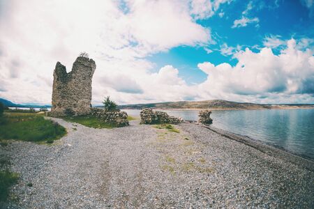 Old destroyed tower near the sea. Sights of Croatia. Small Croatian town on the Adriatic coast.の写真素材