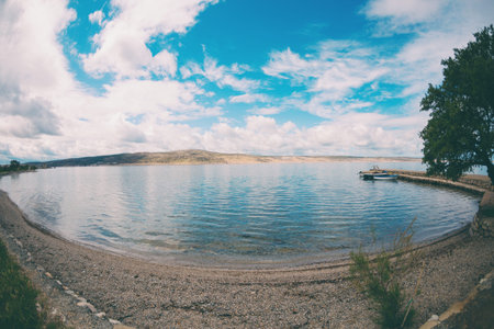 Sea coast of Croatia. Sea and sky with clouds. Calm water.