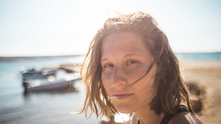 portrait of a girl with freckles on her face. hair that spills in the wind. beautiful and happy.