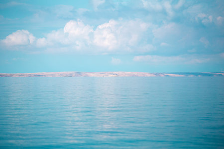 Sea and sky with clouds. Adriatic coast of Croatia. Calm sea surface.