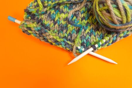 Knitting. Knitting needles and multi-colored threads. A ball of thick thread.の写真素材