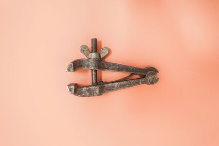 Old rusty tool. Vise on an orange background. Metal work tool.の写真素材