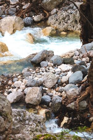 Lake in the forest. Mountain river with rocky shores. Large pebbles at the bottom of the river. Pure water. Clear water.の写真素材