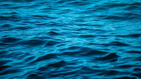 Water surface. Texture. The turquoise sea. Ocean waves. Ripples on the water.の写真素材