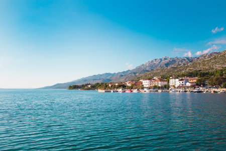 Mountains and the sea. Adriatic coast of Croatia. Town by the sea. Seaside city against the sky with...