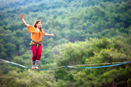 Highliner on a rope. Highline on a background of mountains. Extreme sport on the nature. Balancing...