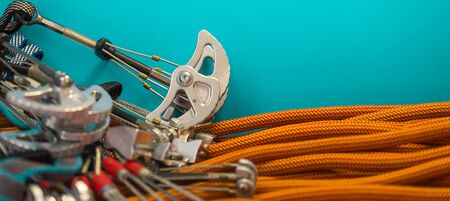 climbing equipment folded on an orange rope. modern equipment for climbing in the mountains. adventure on the rocks.の写真素材