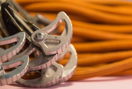 climbing equipment folded on an orange rope. modern equipment for climbing in the mountains. adventure on the rocks.の写真素材