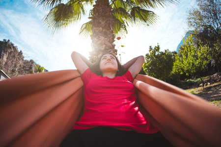 A smiling woman is lying in a hammock. The girl is resting in nature. Camping. Holidays in Turkey....