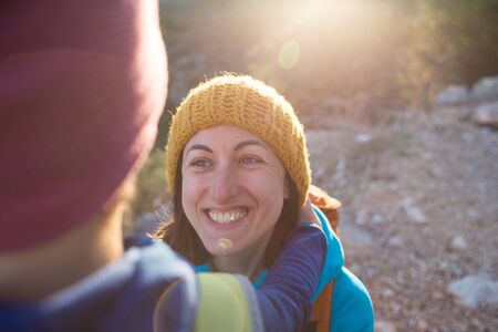 Portrait of a boy. Mom hugs her son. A smiling woman spends time with a child in nature at sunset. A cute kid is hugging his mother.の写真素材