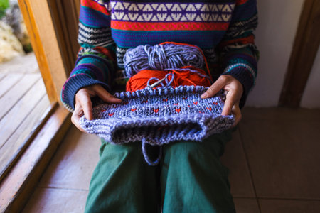 Female hands close-up, Young woman is knitting. Knitting needles and threads. Multi-colored yarn....