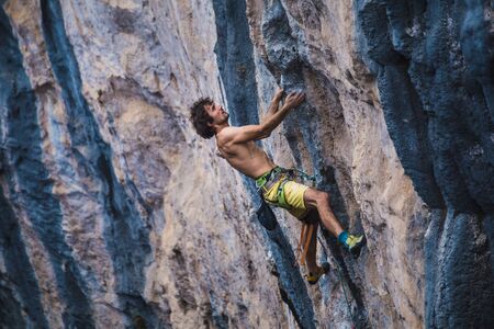 A strong man climbs a rock, Strong back muscles, Rock climbing in Turkey, Training endurance and strength, man in extreme sport, Rock climber is training in nature.の写真素材