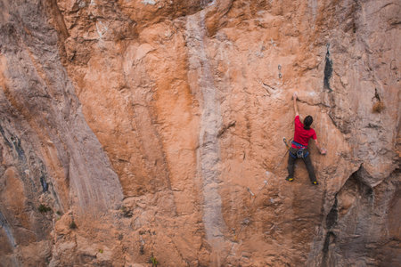 A strong man climbs a rock, Strong back muscles, Rock climbing in Turkey, Training endurance and strength, man in extreme sport, Rock climber is training in nature.の写真素材
