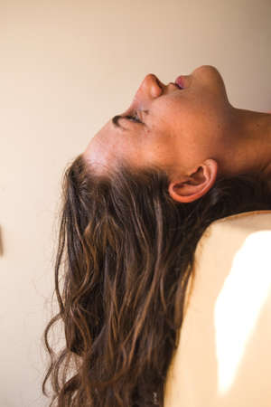 A woman with a backpack stands on top of a mountain and admires the beauty of a mountain valley, The girl travels to beautiful places, Reaching the goal. Beautiful landscape.の写真素材