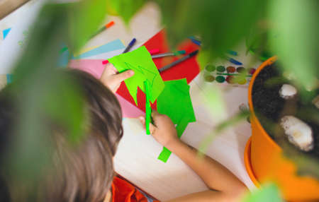 the child prepares for the new year and christmas and cuts paper decorationsの写真素材