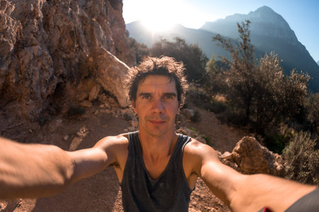 A man takes a selfie against the backdrop of a beautiful mountain valley and rocks, A man travels...