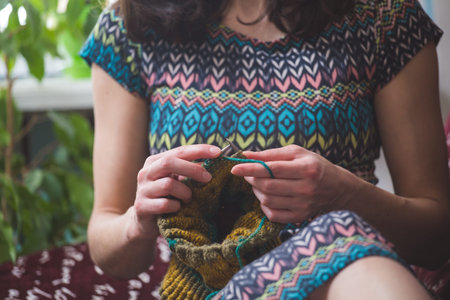 woman knits. home woolen clothes. in her free time, the girl is engaged in a hobby.の写真素材