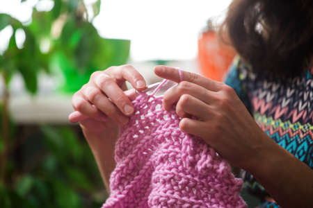 woman knits. home woolen clothes. in her free time, the girl is engaged in a hobby.の写真素材