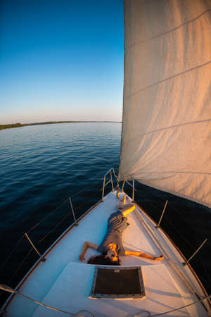 travel on a yacht. girl relaxes on the ship. rest on the deck of a white yacht.の写真素材