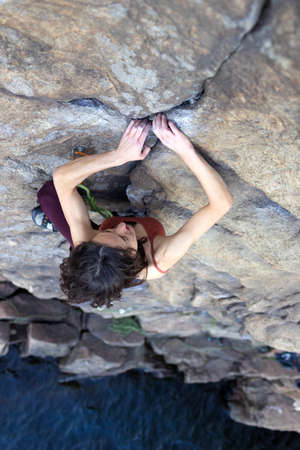 beautiful girl climbs the rock. sport climbing in nature. extreme sport. fitness and beautyの写真素材