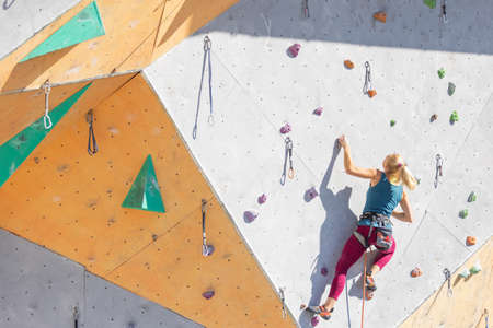 a girl goes through a difficult route in rock climbing training. sport climbingの写真素材