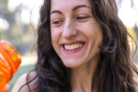 girl drinks water while doing sports on the street. sports and healthy lifestyle.の写真素材