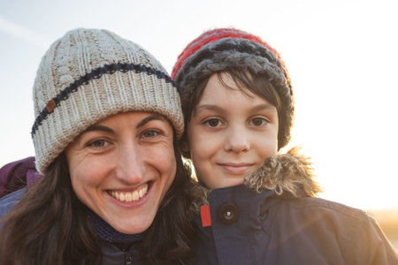 mom and son have fun and hug on the street while walking. portrait of a happy child next to mom.