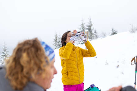 winter camping in mountains, two women in winter trekkingの写真素材