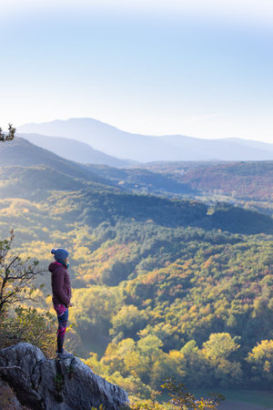 A woman meets the sunset in a beautiful traveling place, the girl enjoys a beautiful view from the...