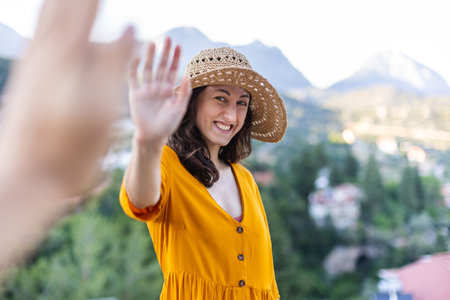 portrait of a beautiful young girl in a summer hat on the street. straw hat.の写真素材